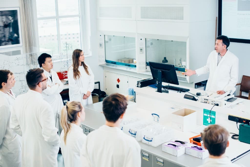 Researchers gathered around a workstation in a laboratory